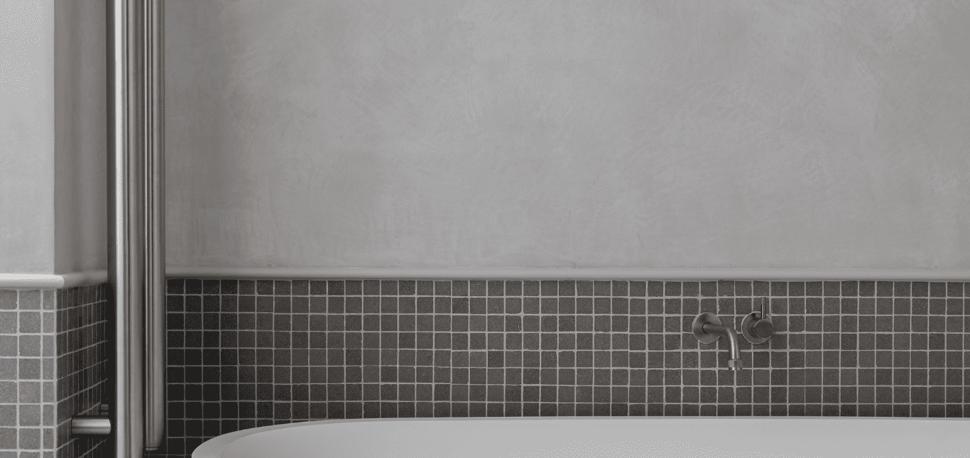 Microcement wall above bathtub — mineral surface in a Sydney bathroom